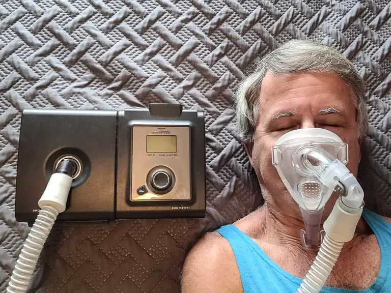 Man sleeping comfortably while wearing a CPAP machine