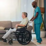 Young man, senior or wheelchair help in nursing home or retirement house in surgery rehabilitation,.